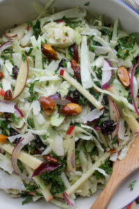 Crispy kale salad with cabbage, apples, almonds and raisins.