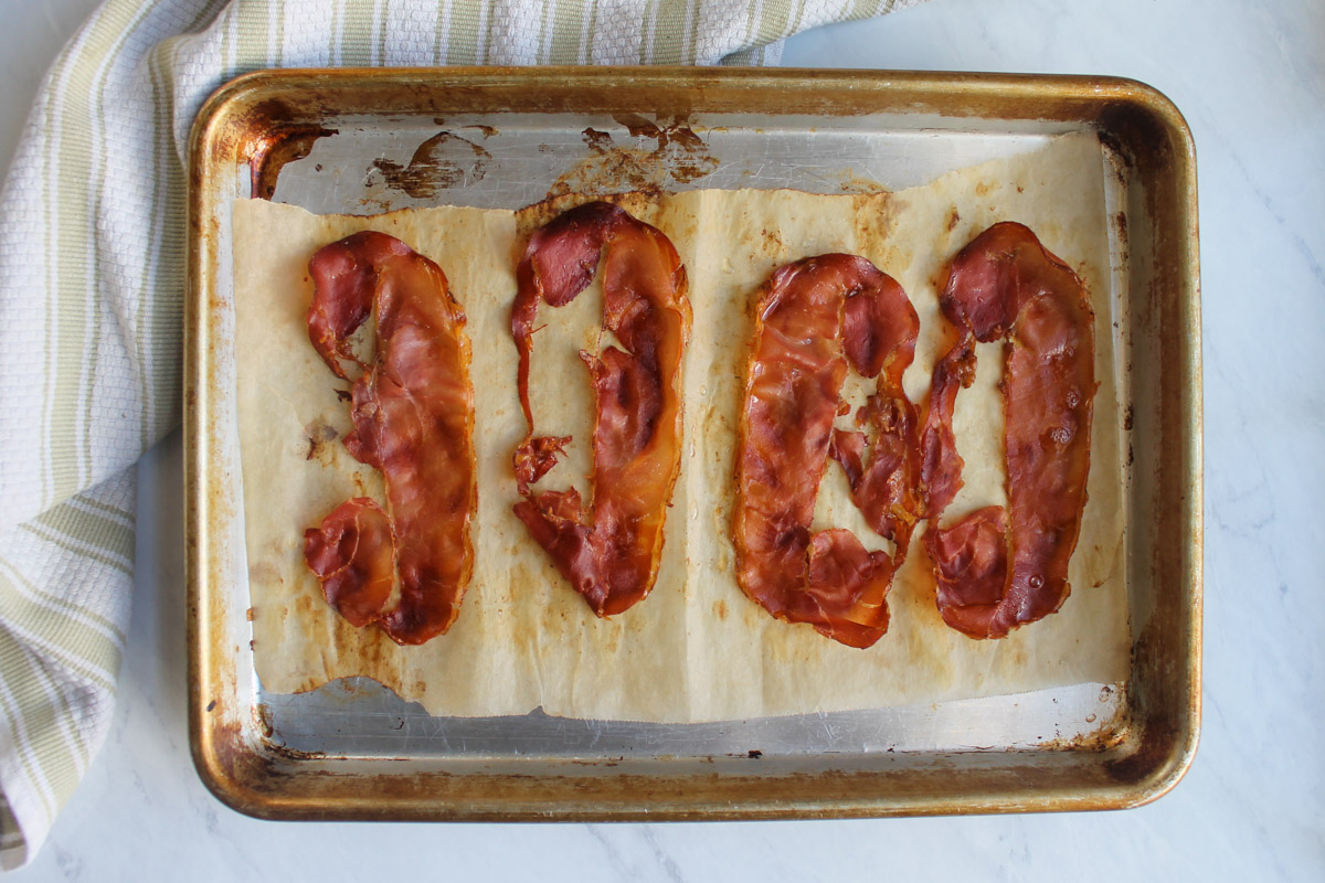 Crispy prosciutto on a baking sheet that has been baked in the oven.