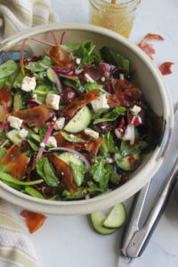 Italian salad with prosciutto, feta, olives and red onion.