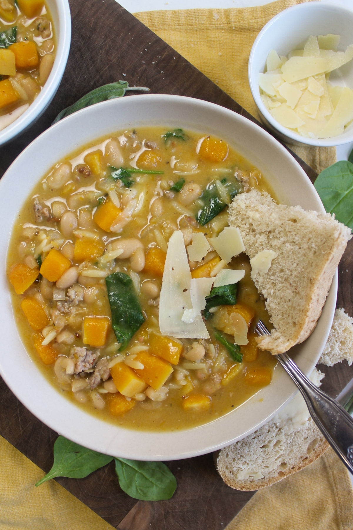 A bowl of butternut squash and spinach soup.