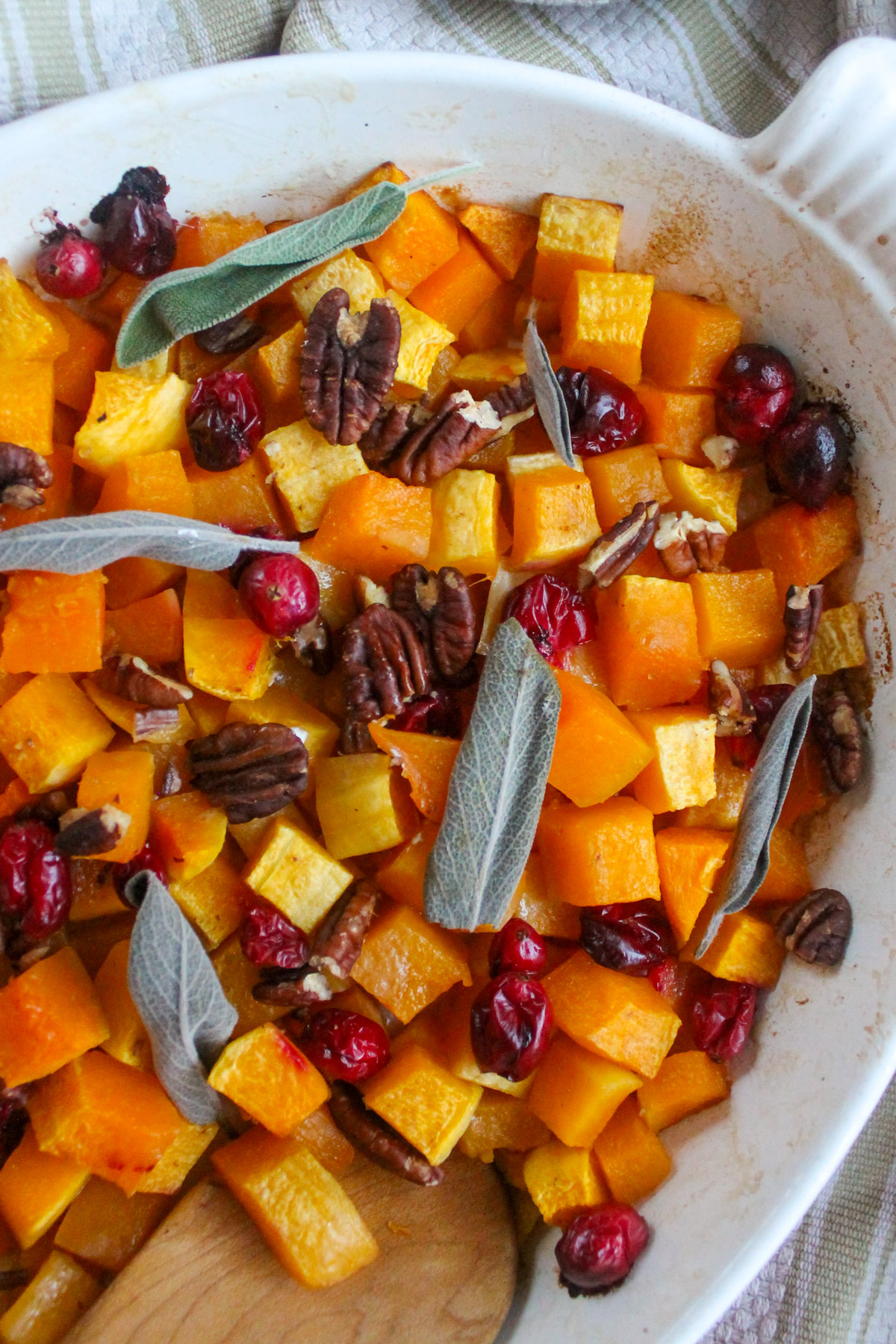 A holiday side dish of roasted butternut squash with cranberries and sage.