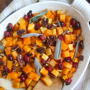 Roasted Butternut Squash with cranberries and pecans and garnished with fresh sage.