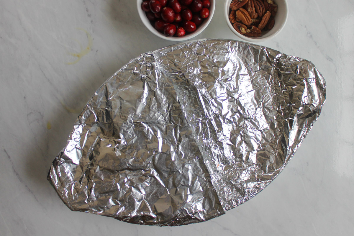 The butternut squash wrapped in foil and ready to bake.