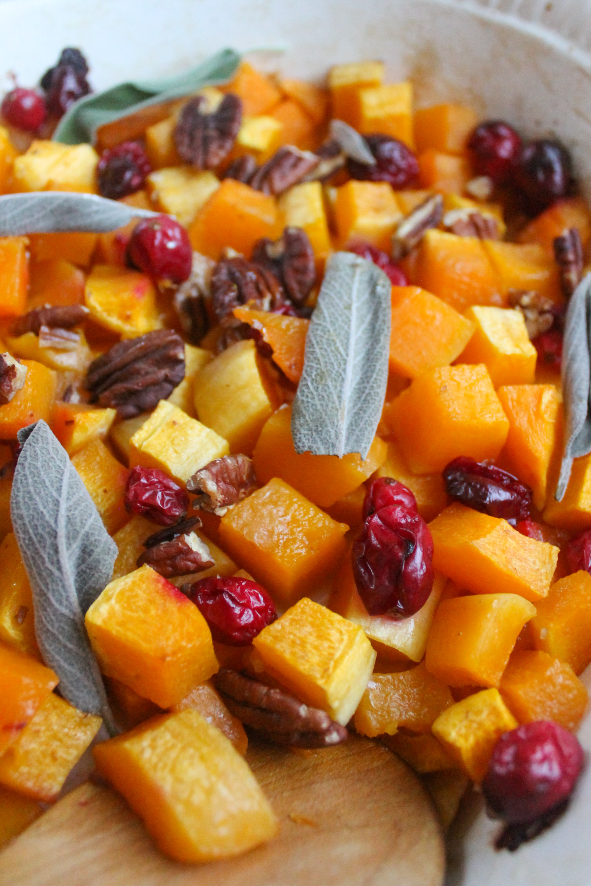 A close up of roasted butternut squash with pecans side dish.
