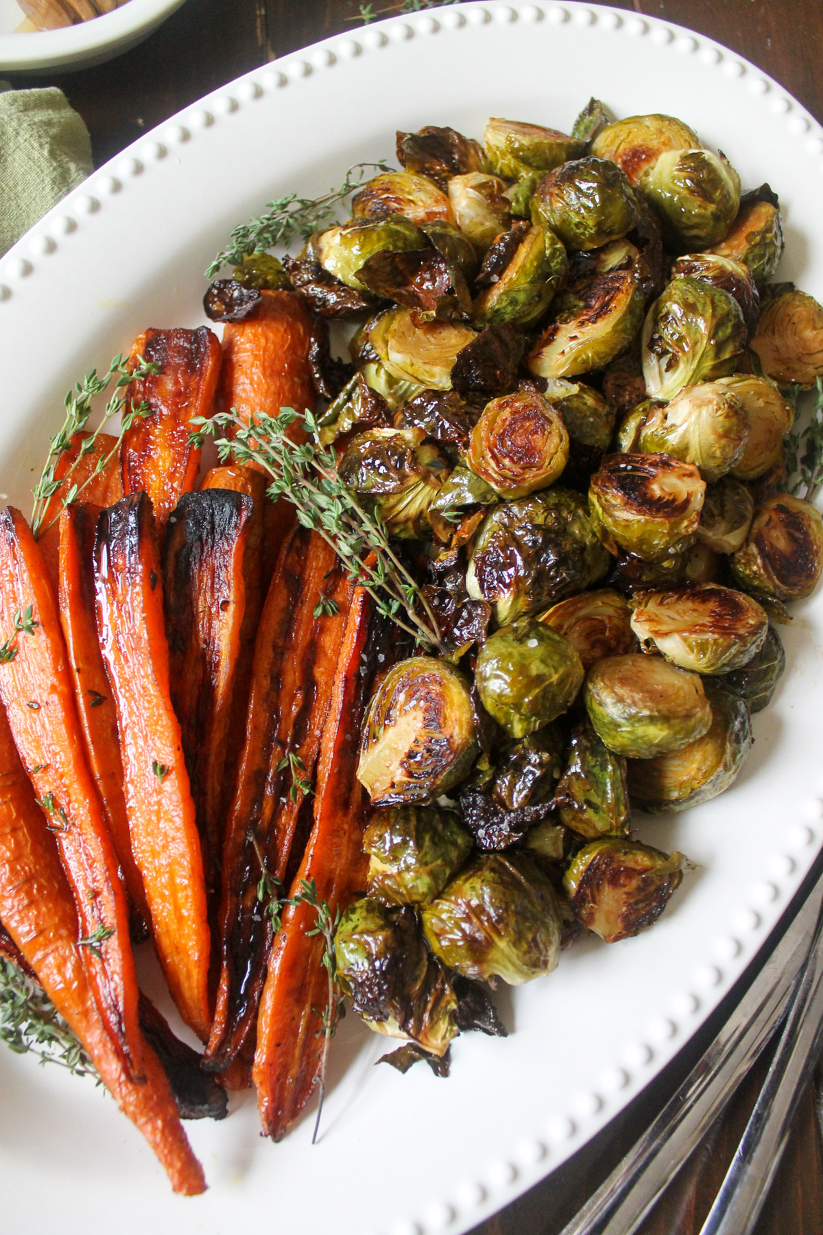 A holiday side dish platter of oven roasted Brussel sprouts and carrots.