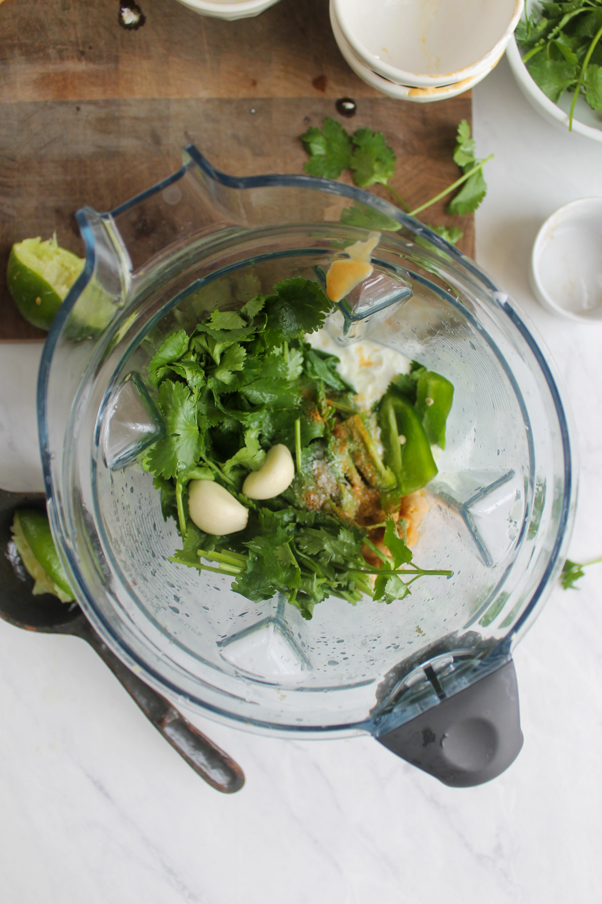 All ingredients for cilantro lime hummus in a blender.