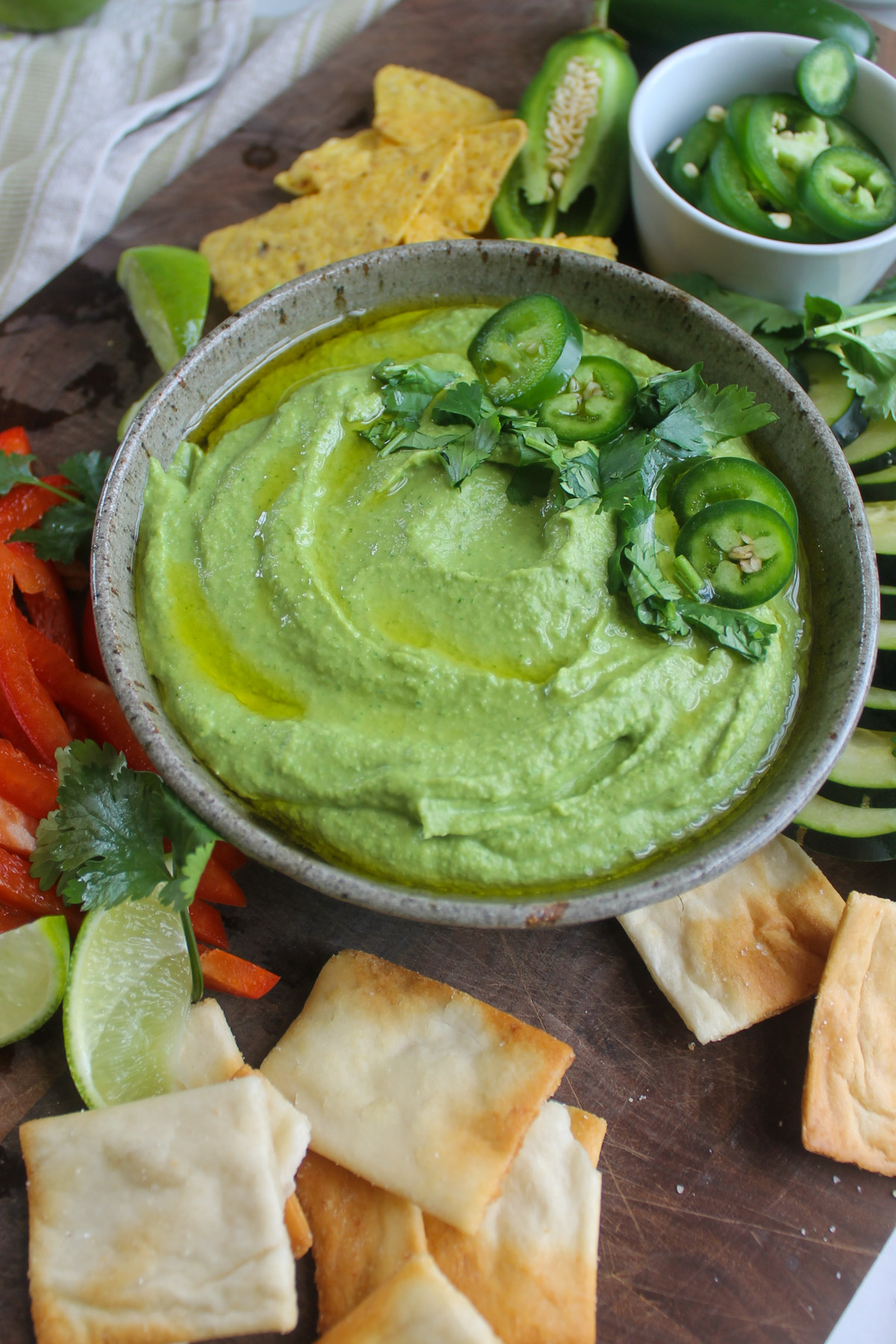 Cilantro lime hummus garnished with fresh jalapeño slices.