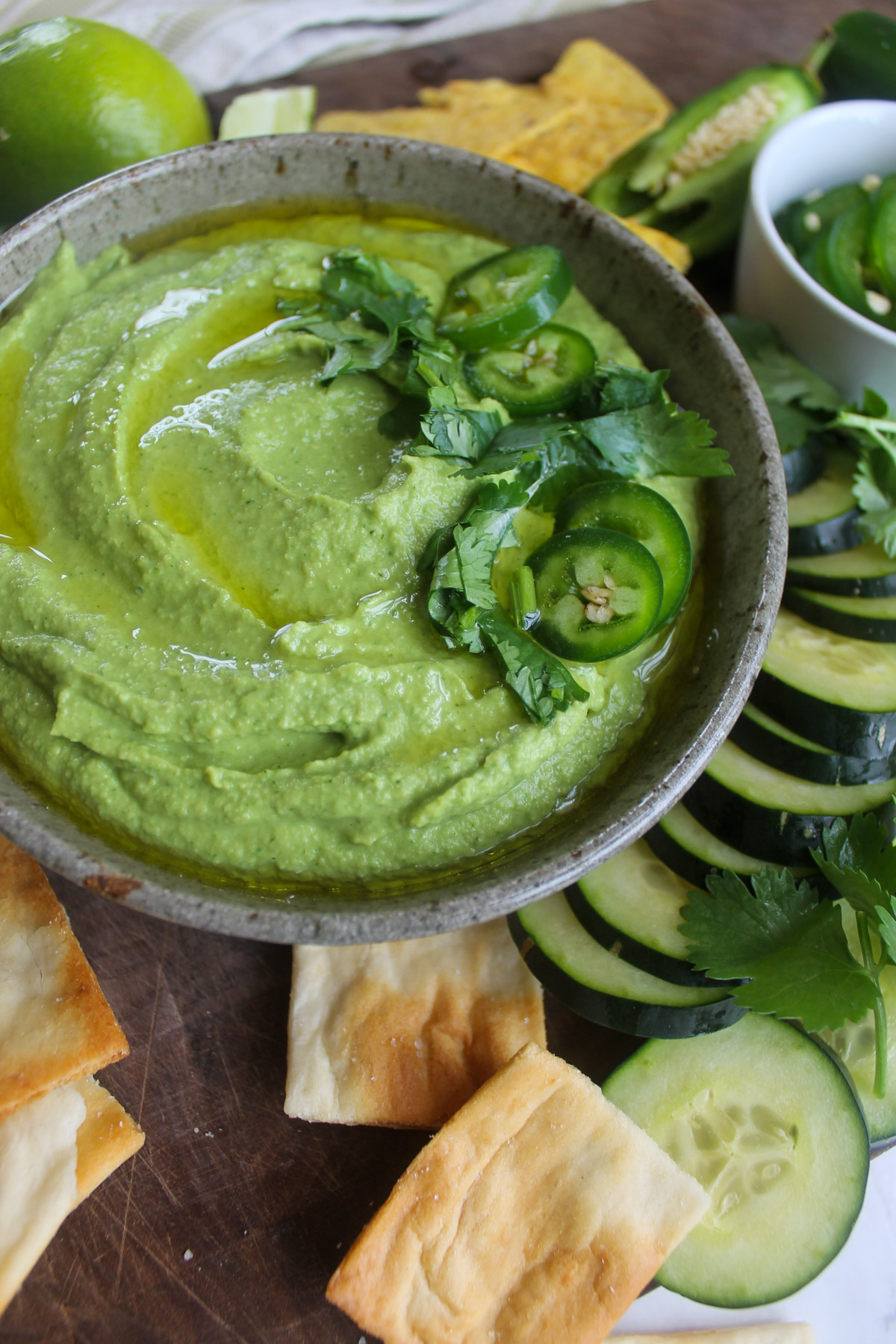 A bowl of super green hummus made with cilantro, lime juice, chickpeas and jalapeño.