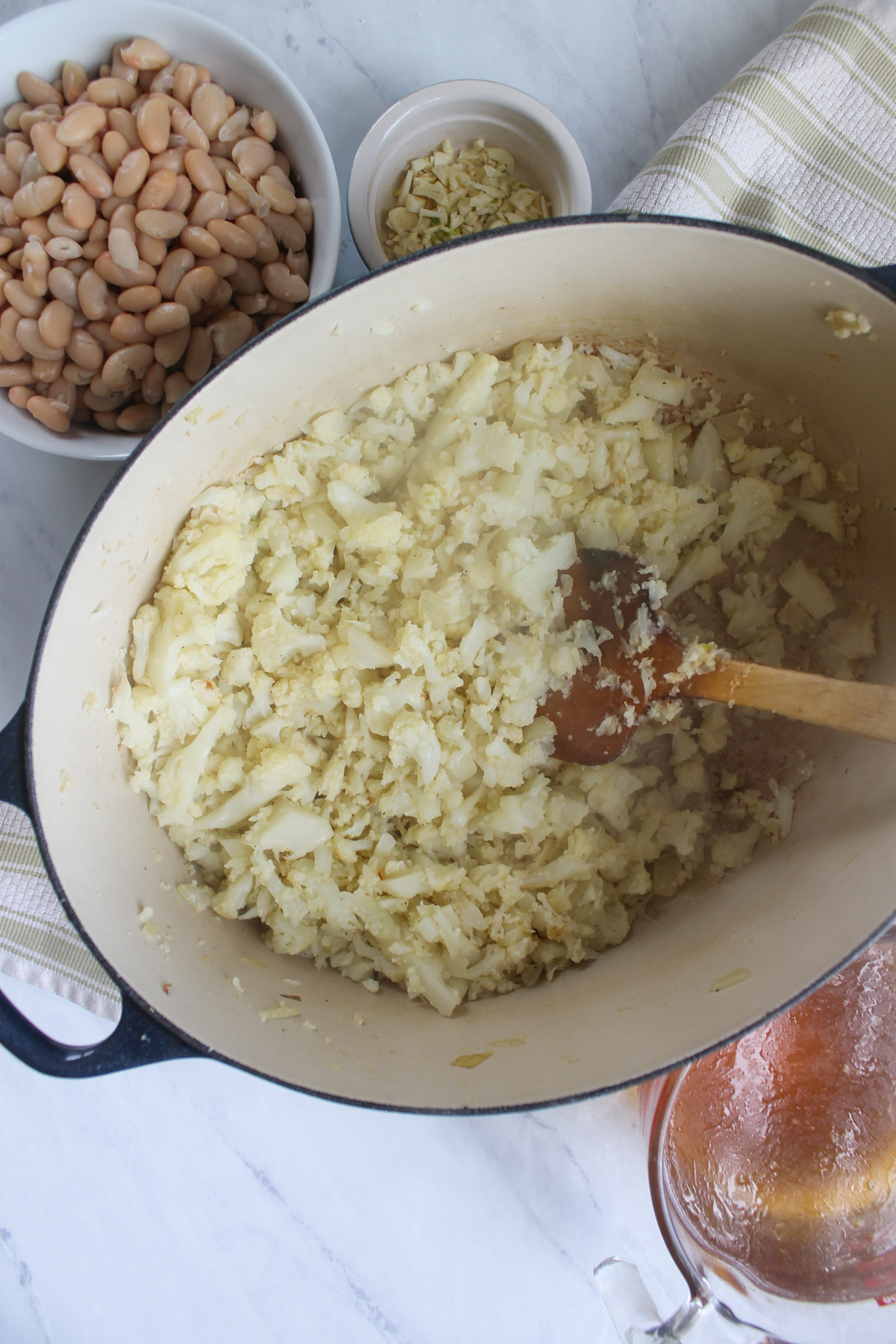 A large soup pot of the sautéed onions and cauliflower.