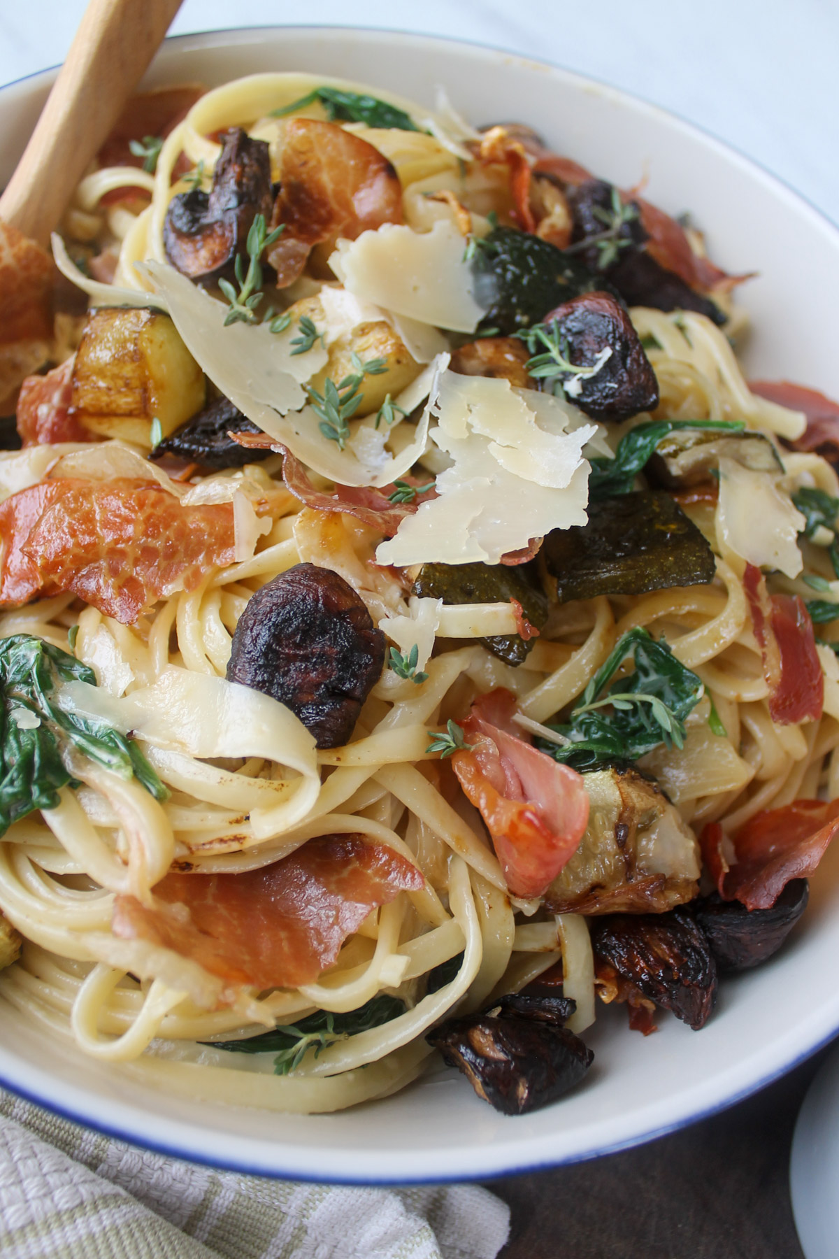 Zucchini mushroom pasta with crispy prosciutto and shaved Parmesan cheese.