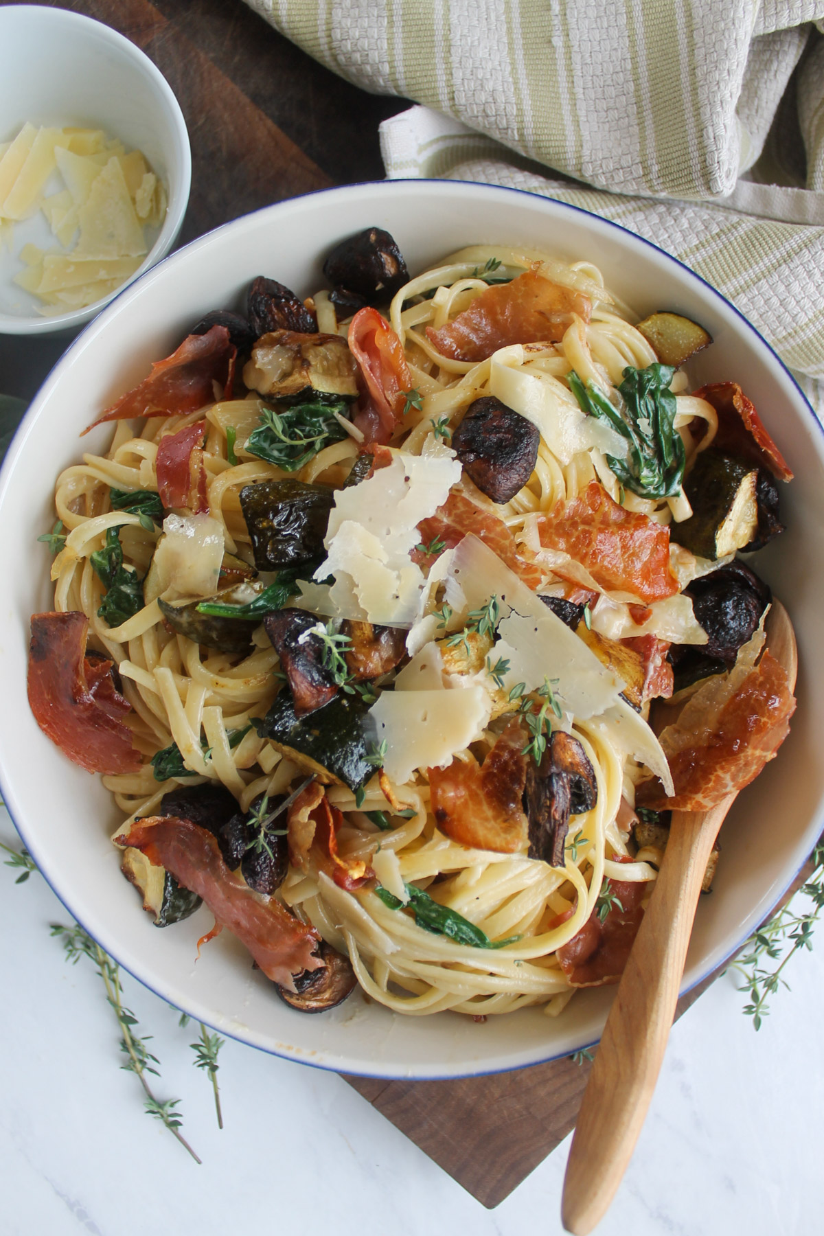 Creamy zucchini and mushroom pasta with crispy prosciutto and fresh thyme leaves.