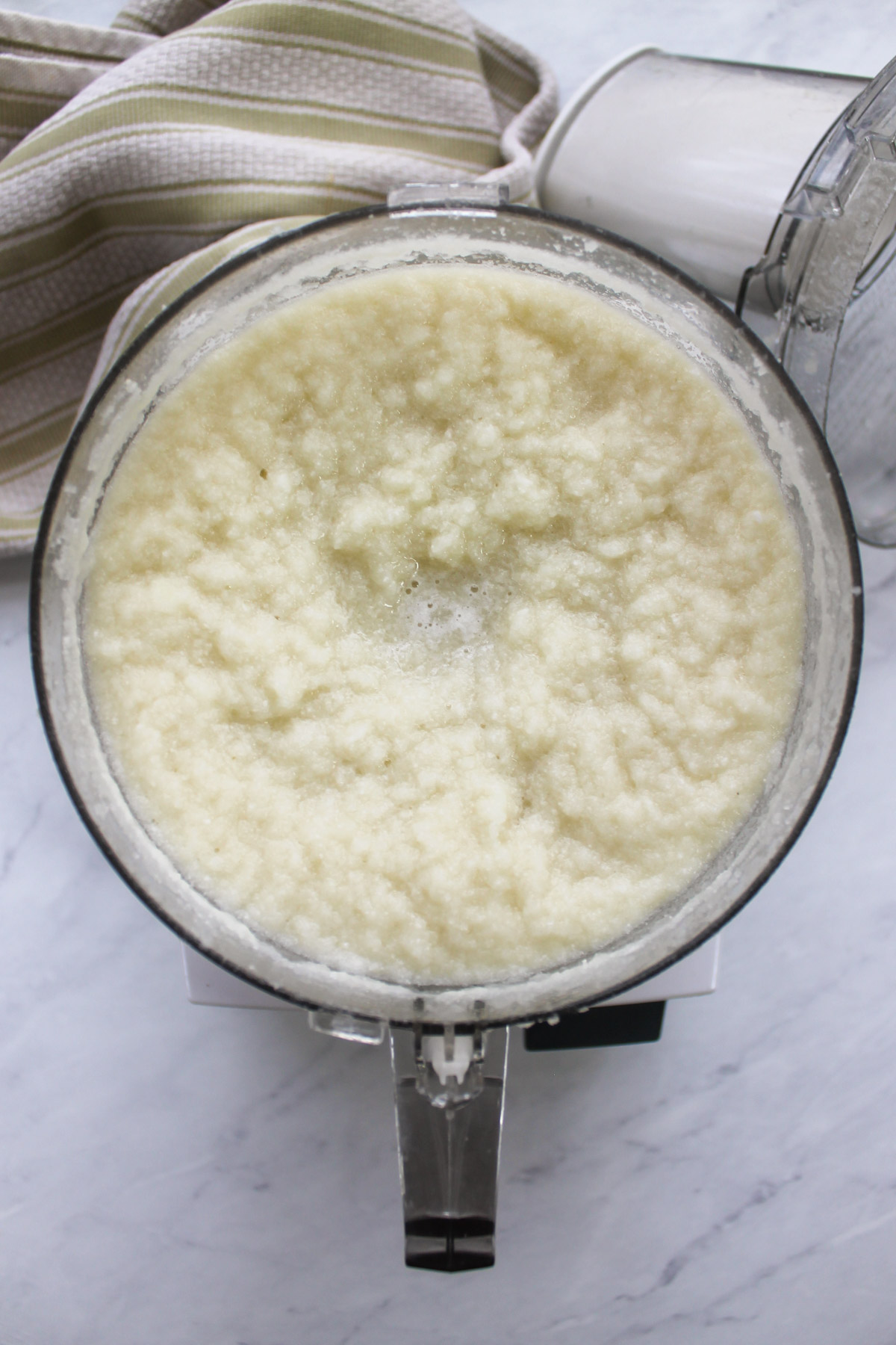 Pureed cauliflower in a food processor blended with water.