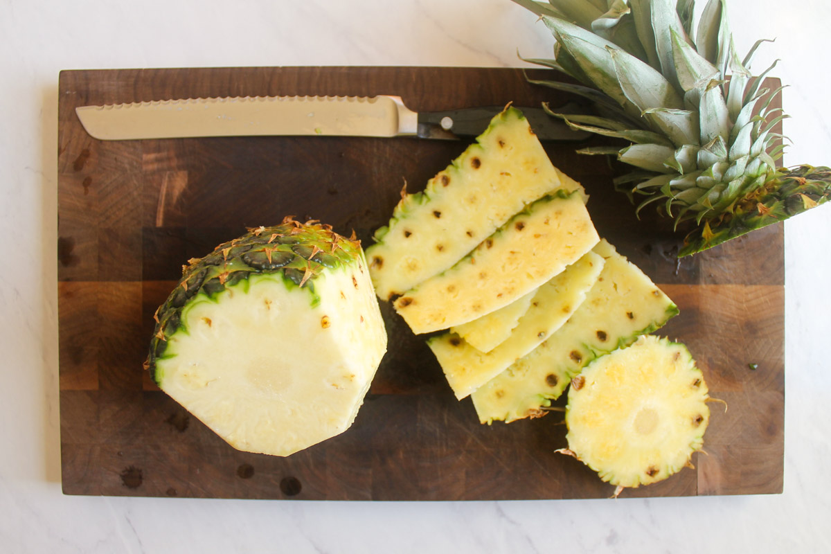 How to Slice a Pineapple by first cutting off the peel.