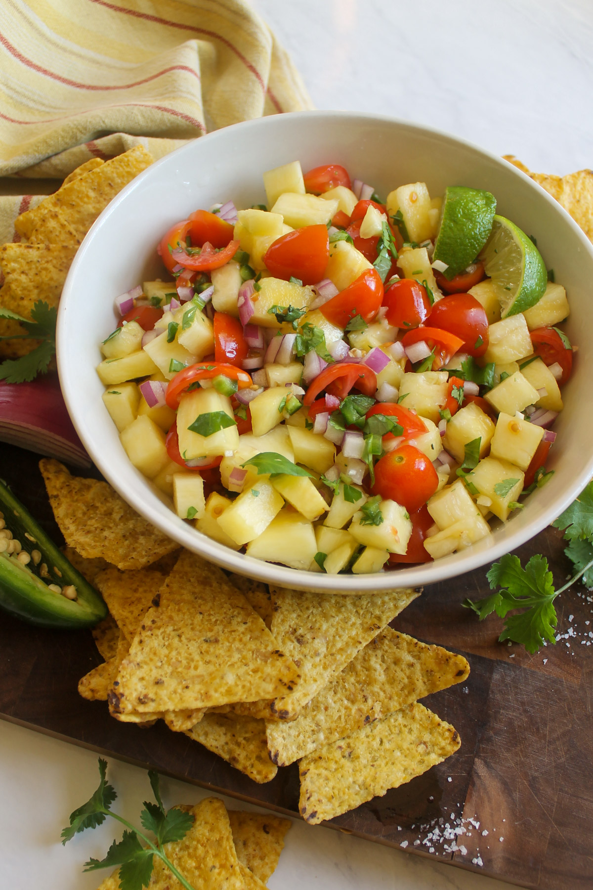 A bowl of pineapple salsa served with tortilla chips.