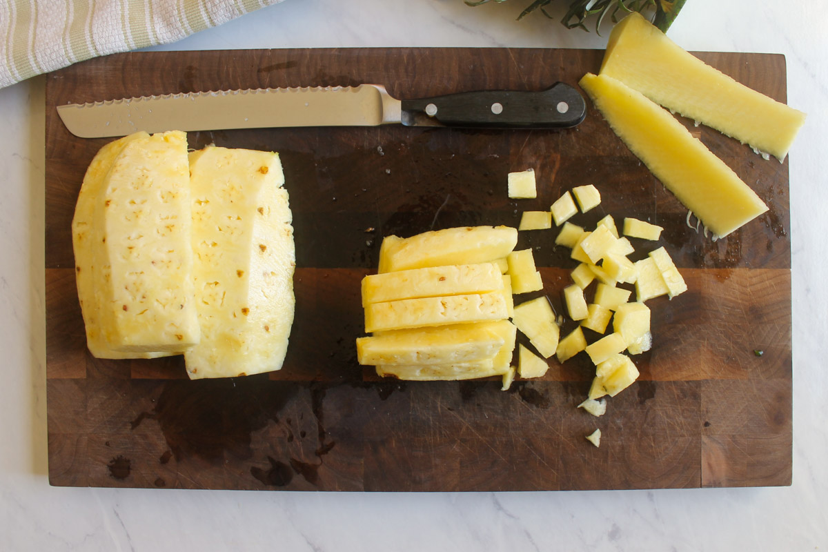 Chopping a pineapple into small cubes for salsa.