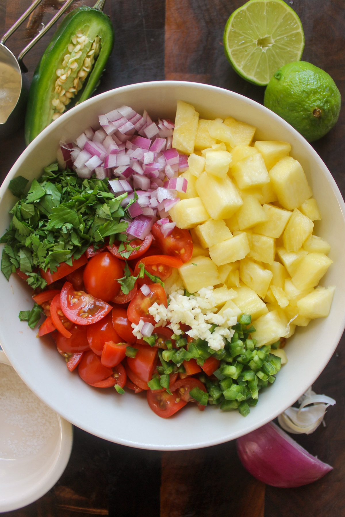 Ingredients for pineapple pico de gallo chopped and in a bowl.