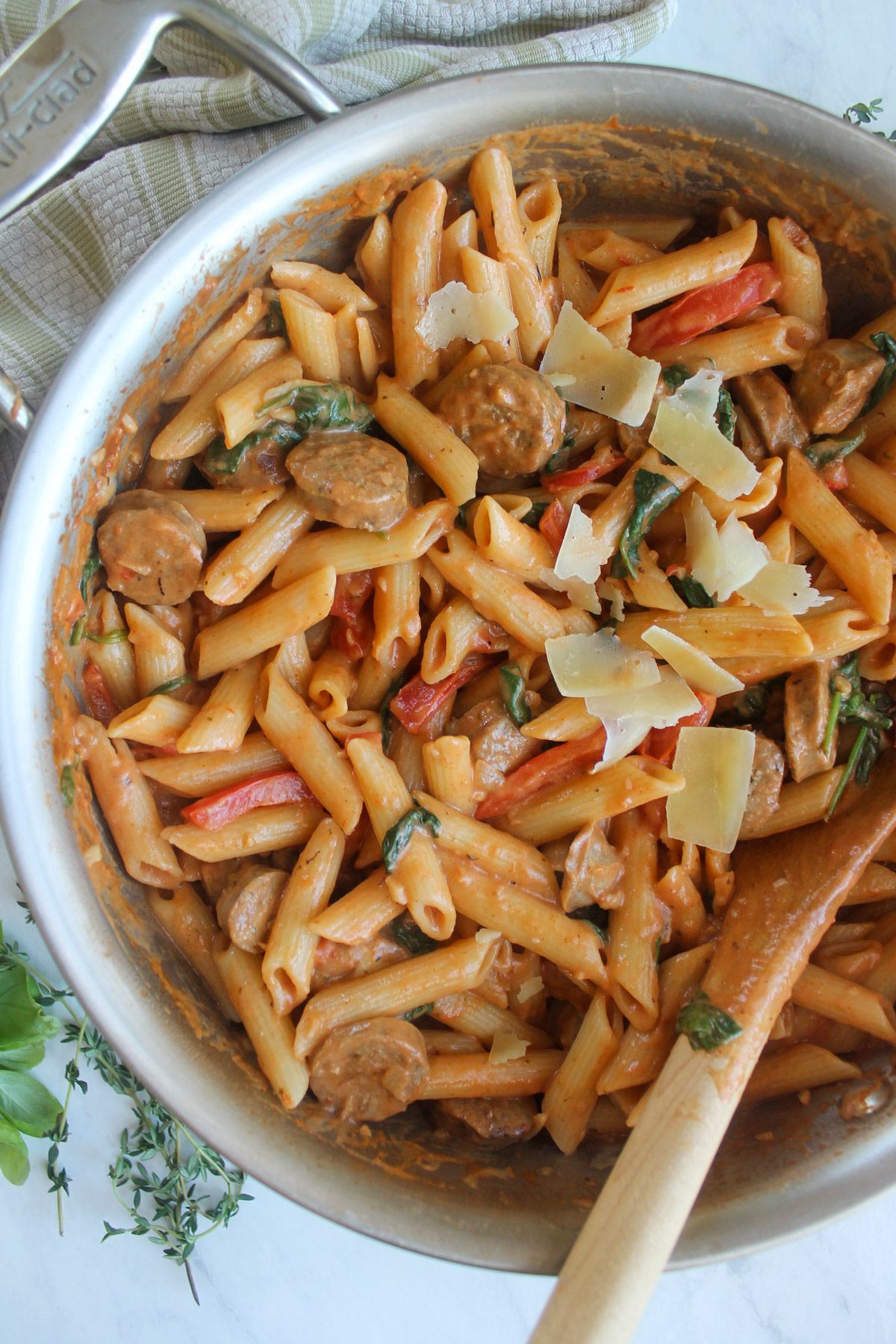Creamy sausage pasta recipe with red bell pepper and spinch.