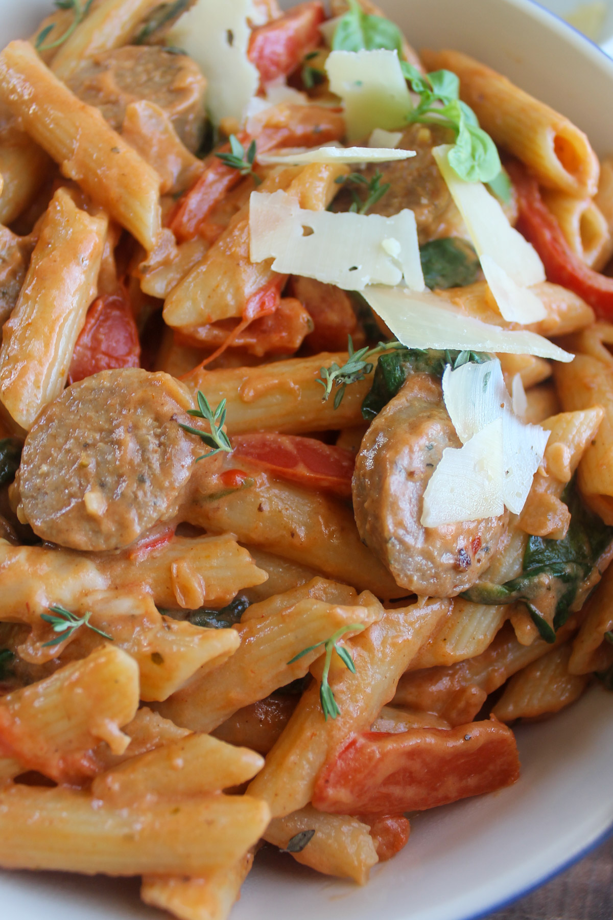 Pink sauce pasta recipe with sliced red bell pepper and Italian sausage.