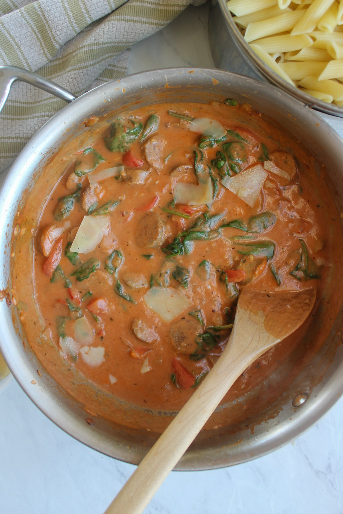 The simmered creamy tomato pink sauce with Italian sausage and spinach, ready to add the pasta.