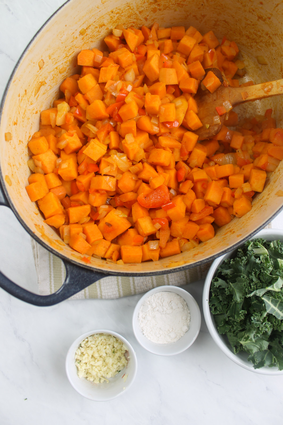 Vegetables in a soup pot have been sautéed.