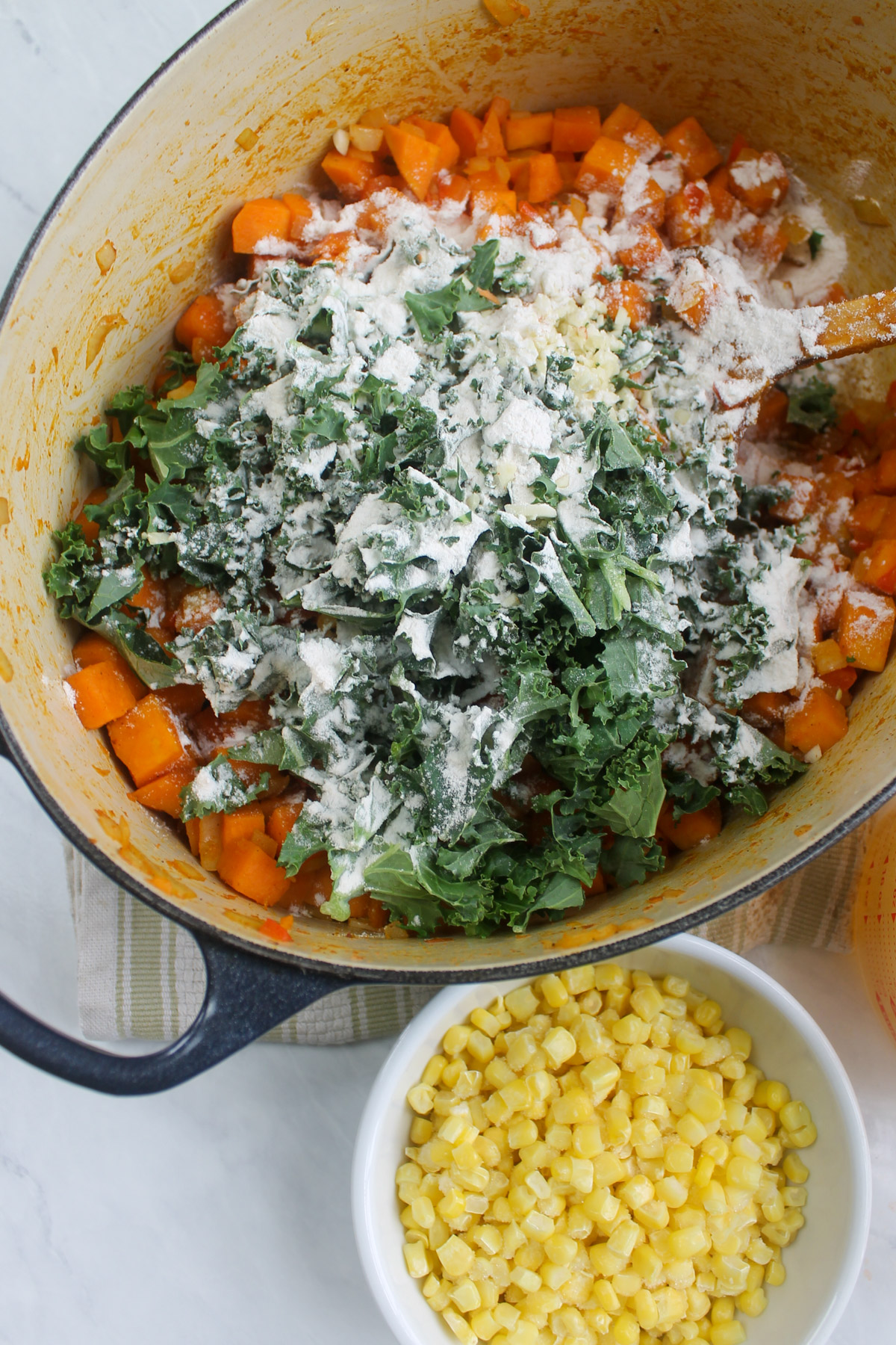 Kale and flour added to the sautéed vegetables.