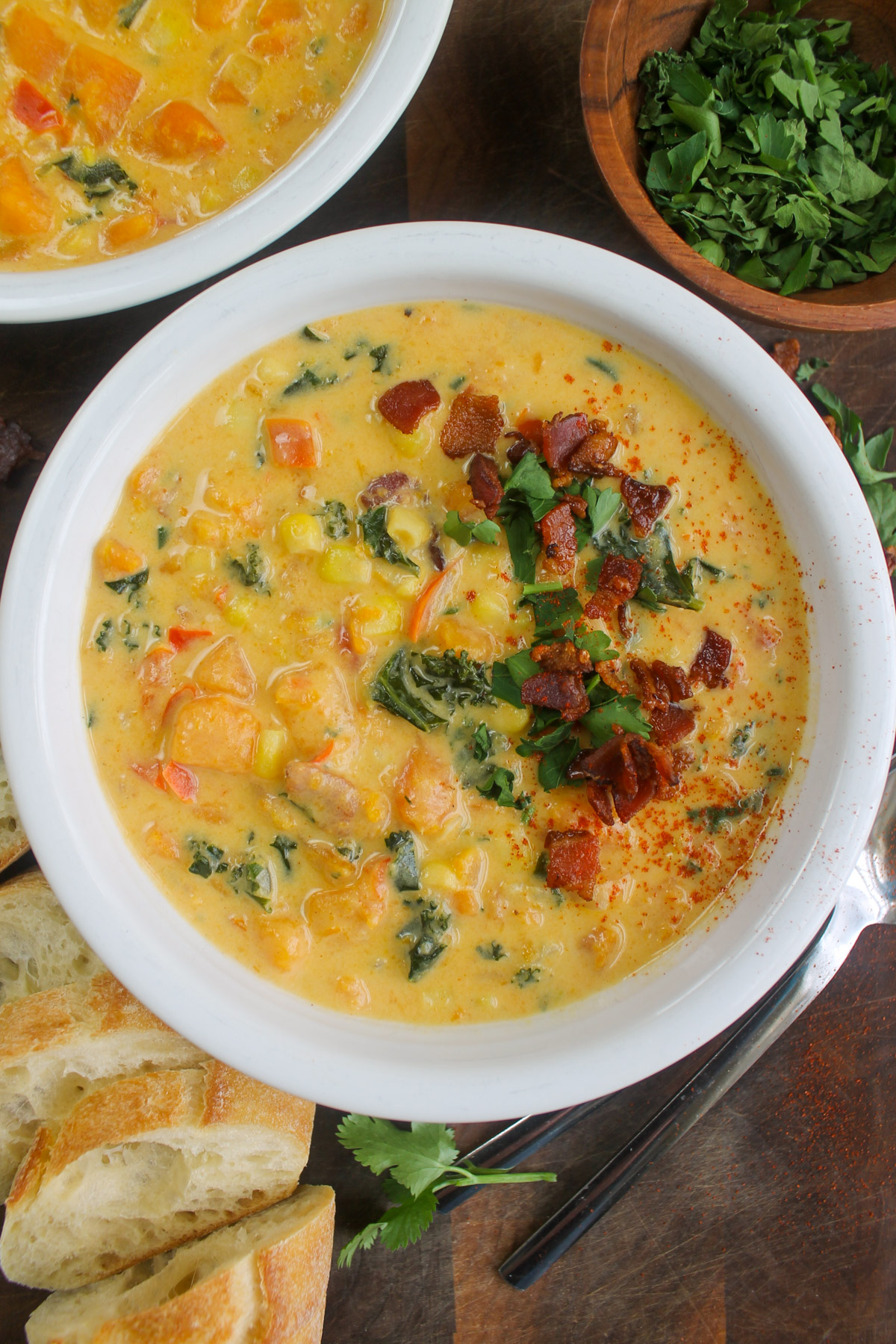 A white bowl of sweet potato bacon corn chowder.