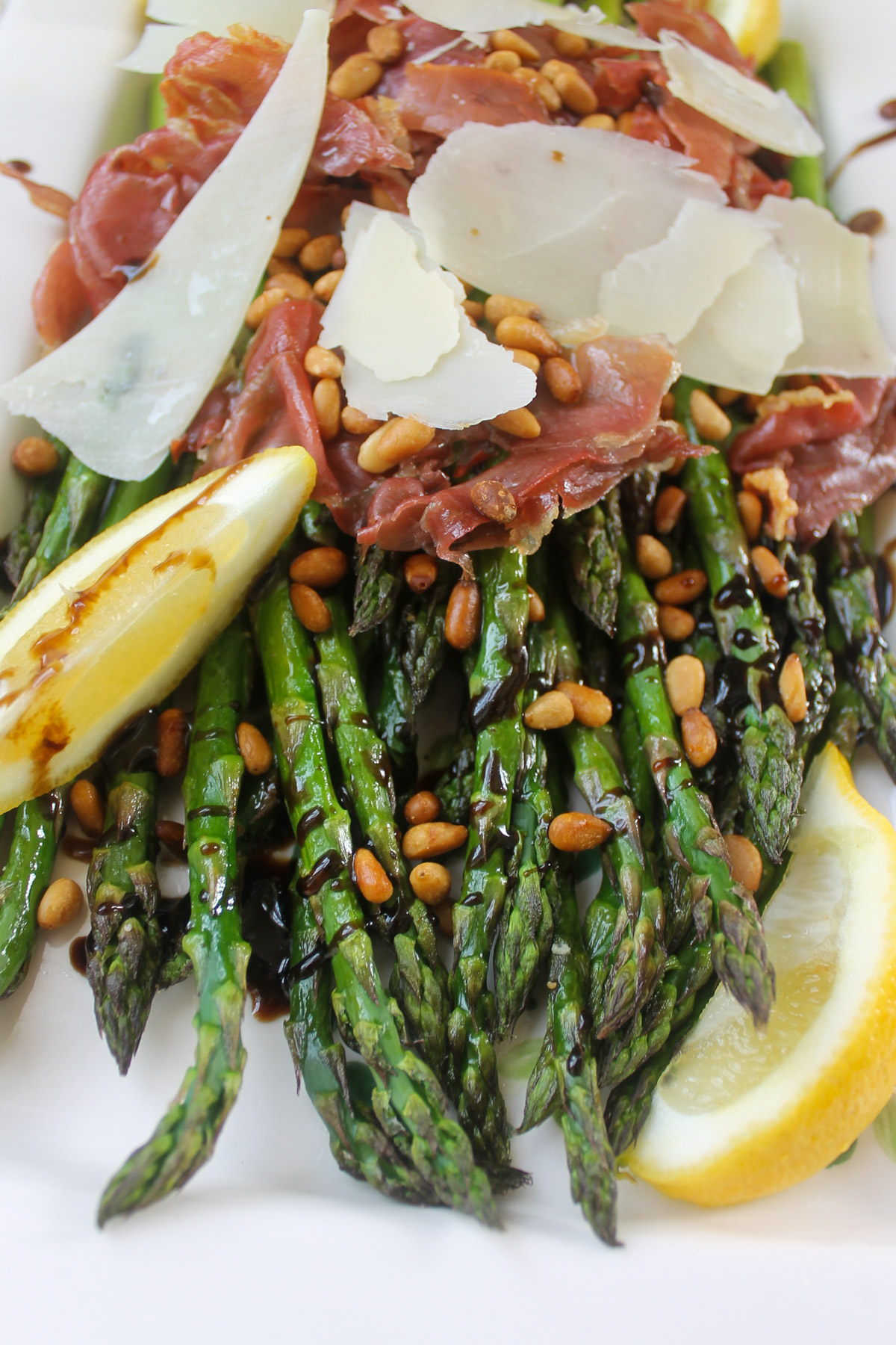 Toasted pine nuts over roasted asparagus drizzled with balsamic glaze.