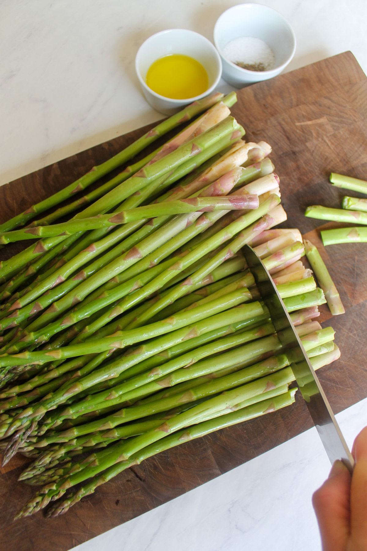 Trimming the ends of asparagus.