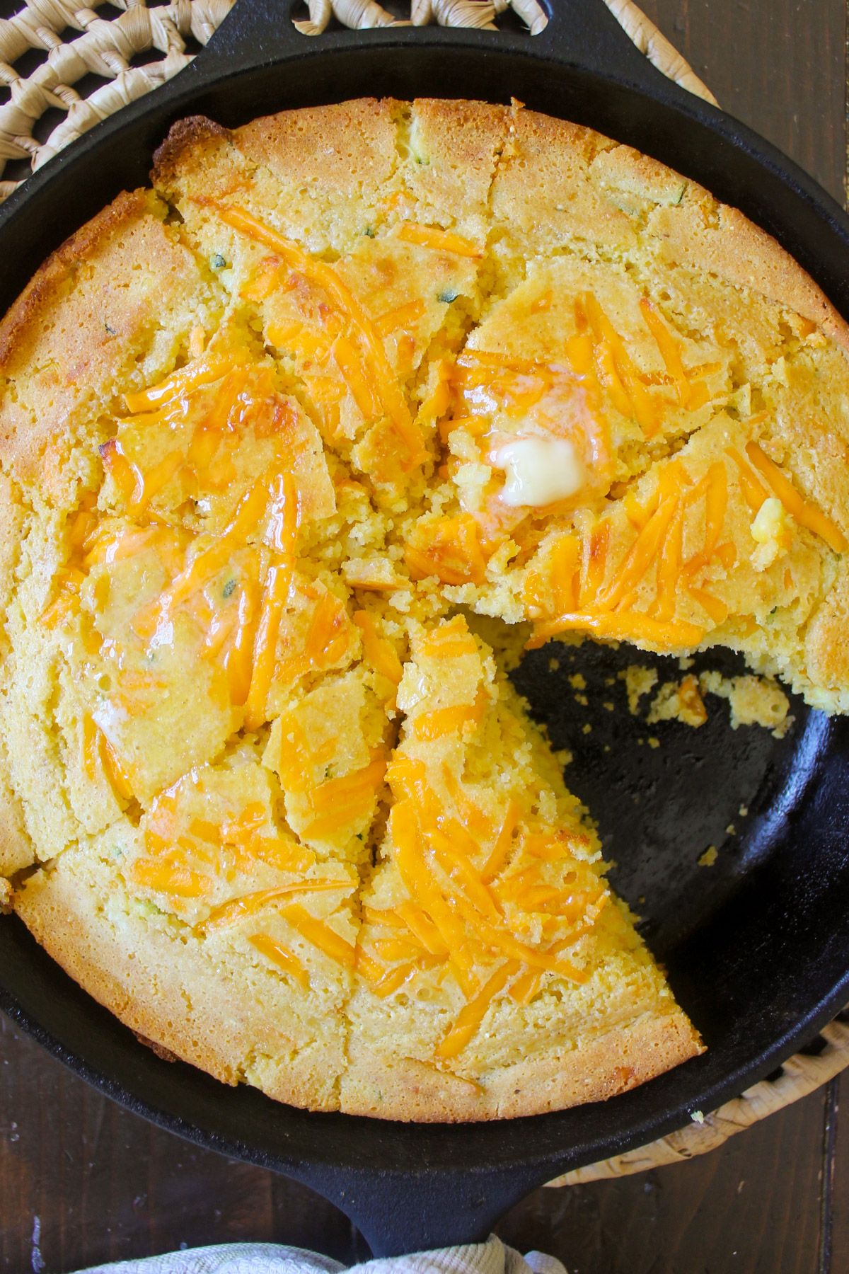 Sliced cornbread in a cast iron skillet.