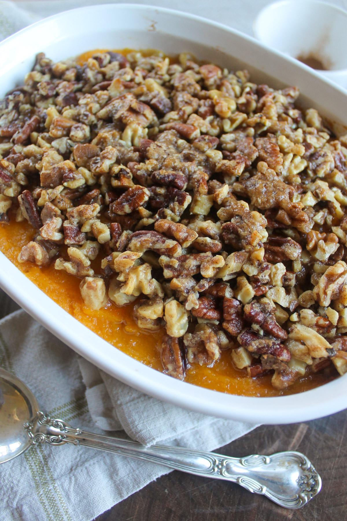 Baked butternut squash casserole with butter pecan topping.