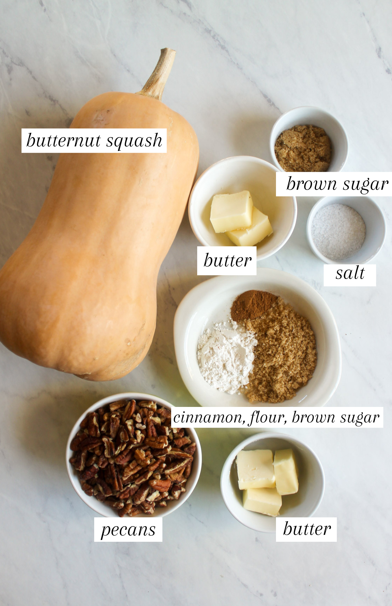 Labeled ingredients for butternut squash casserole on a white counter.