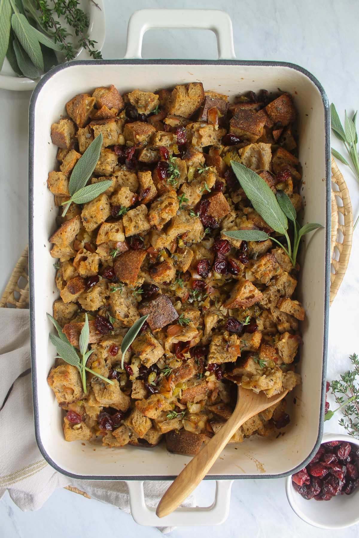 The baked Cranberry Herb Bread Stuffing garnished with fresh sage leaves.
