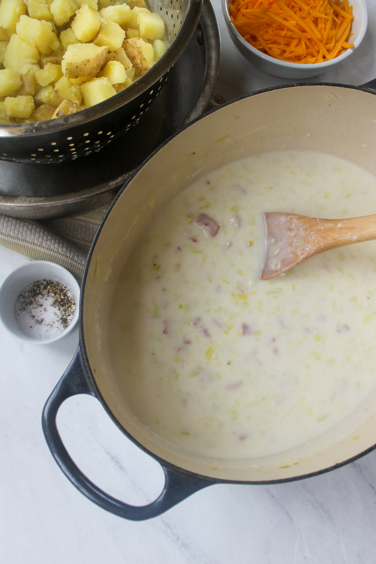 The thickened soup next to the drained potatoes in a colander, ready to add.