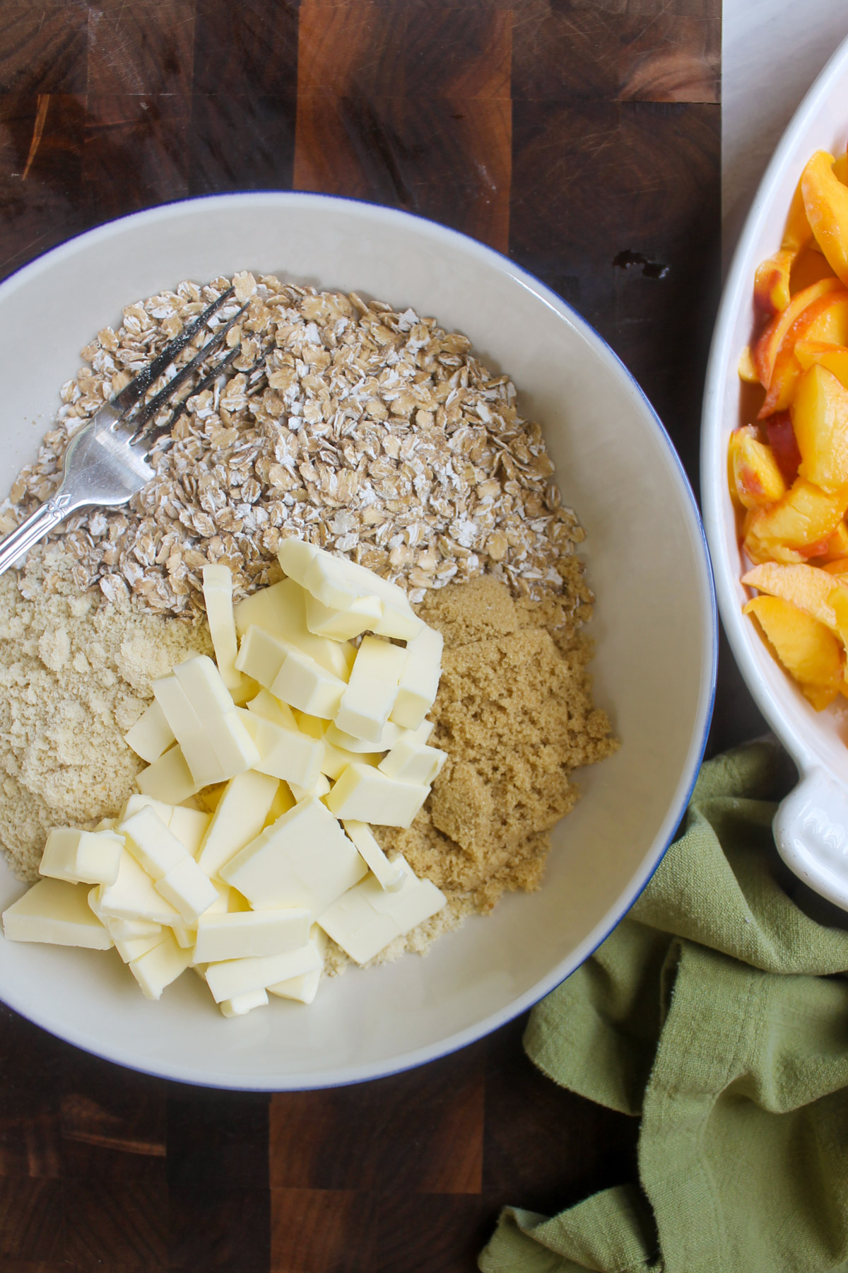 A bowl of ingredients for the peach crisp topping.