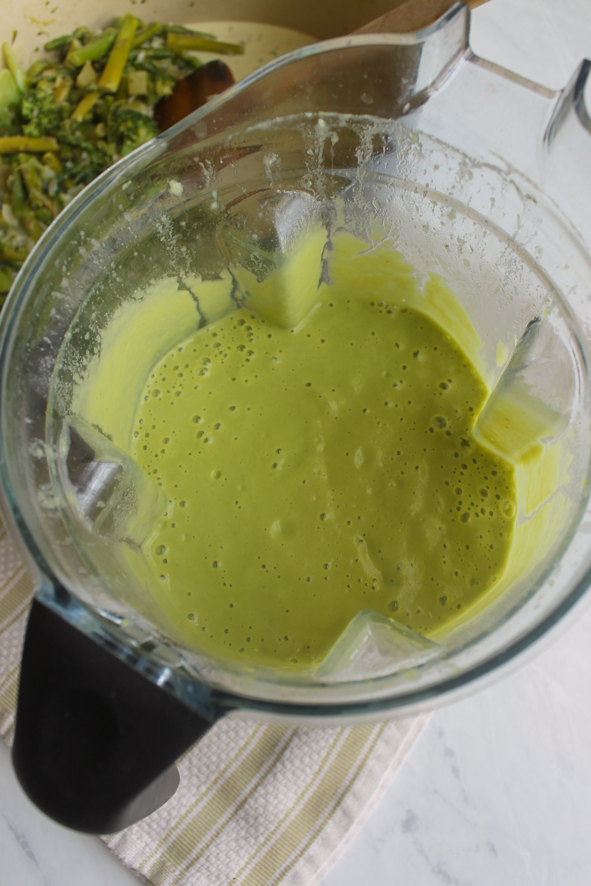 Pureed green Asparagus Broccoli Soup in a blender.