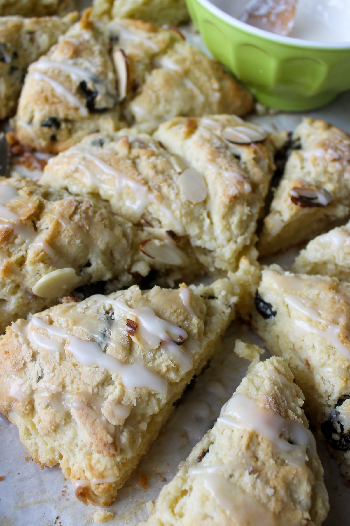 A round disk of scone cut into wedges with icing.