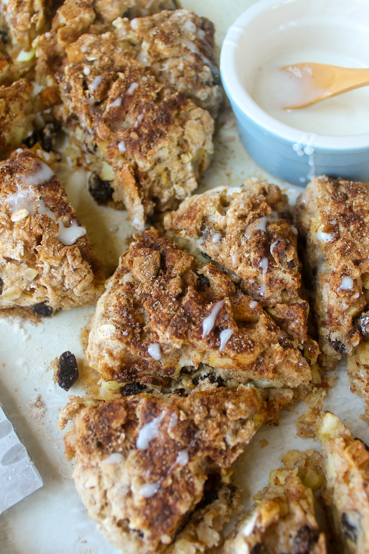 Two rounds of Apple Cinnamon Raisin Scones cut into wedges on a sheet pan.