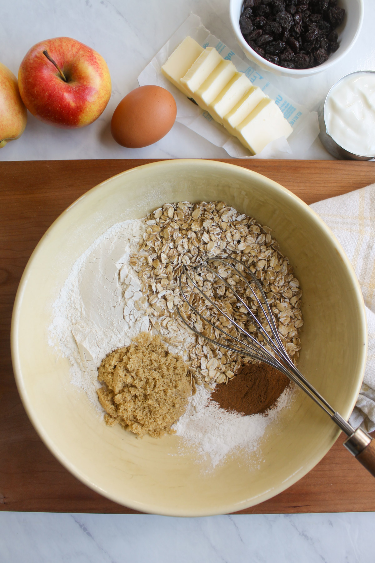 A bowl of dry ingredients for apple raisin scones.