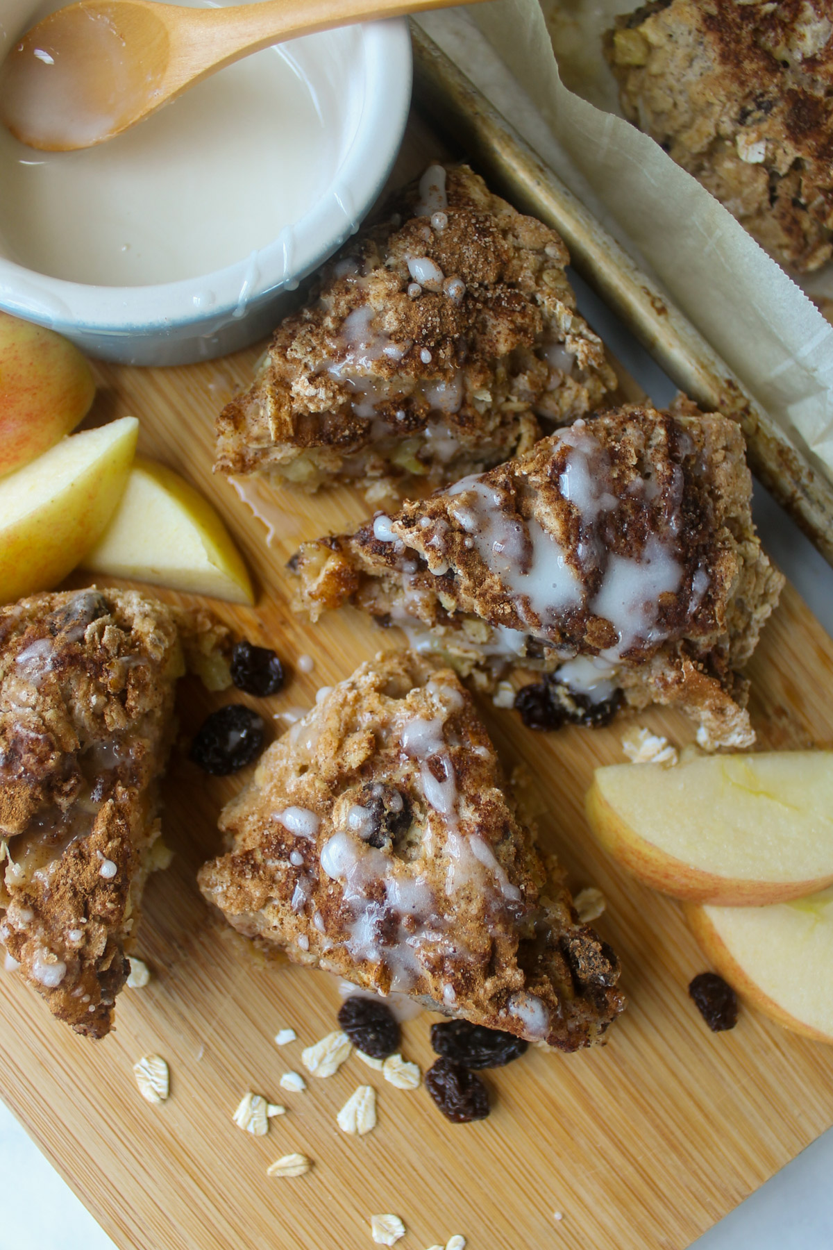 Wedges of Apple Scones on a cutting board with apple slices.