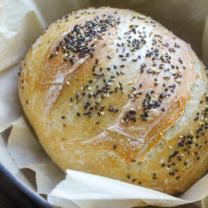 Bread baked in a Dutch oven with seeds on top.