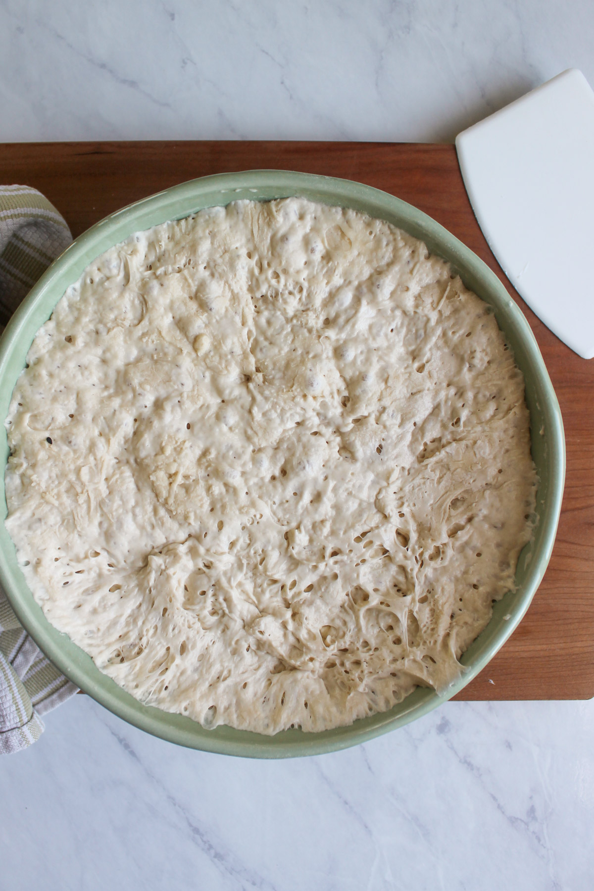 A bowl of bread dough doubled in size after sitting overnight.