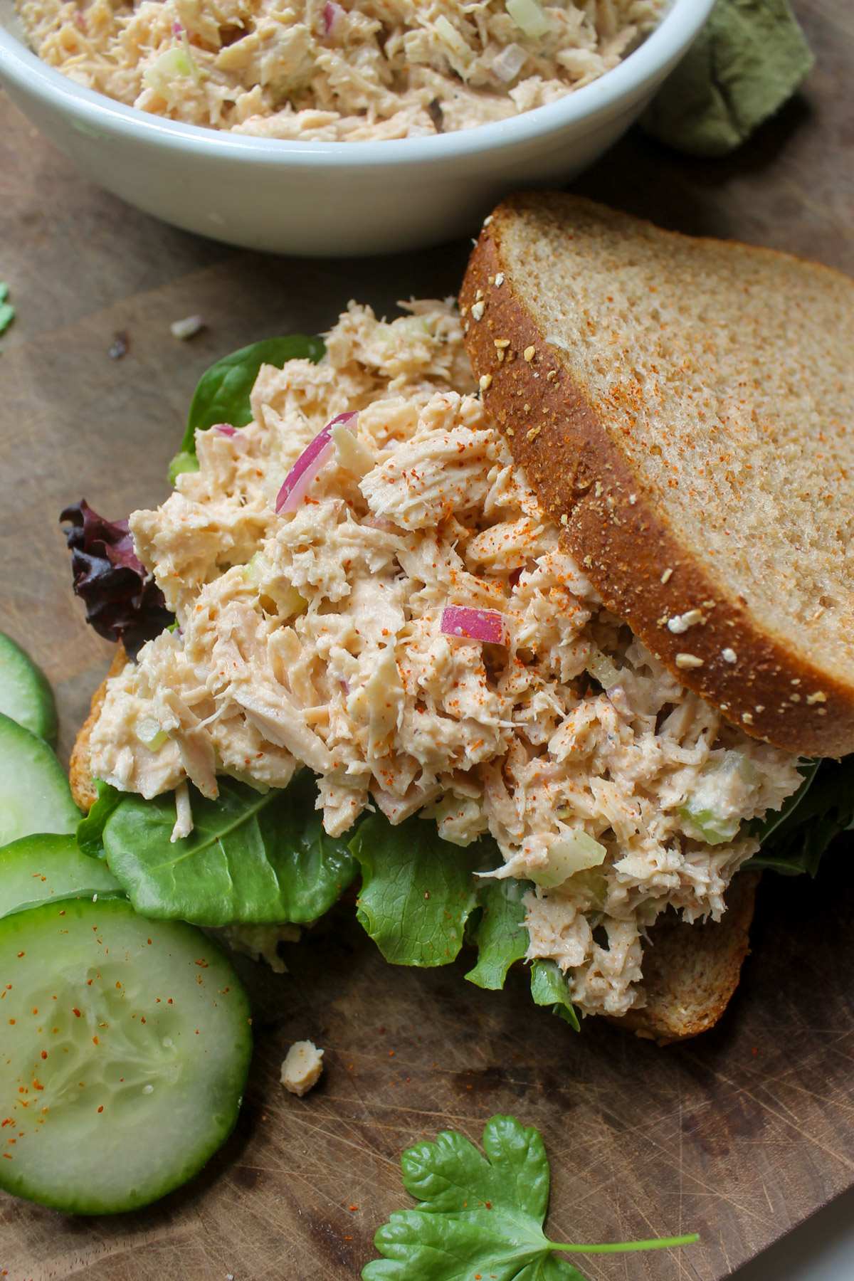A tuna salad sandwich open faced on bread.