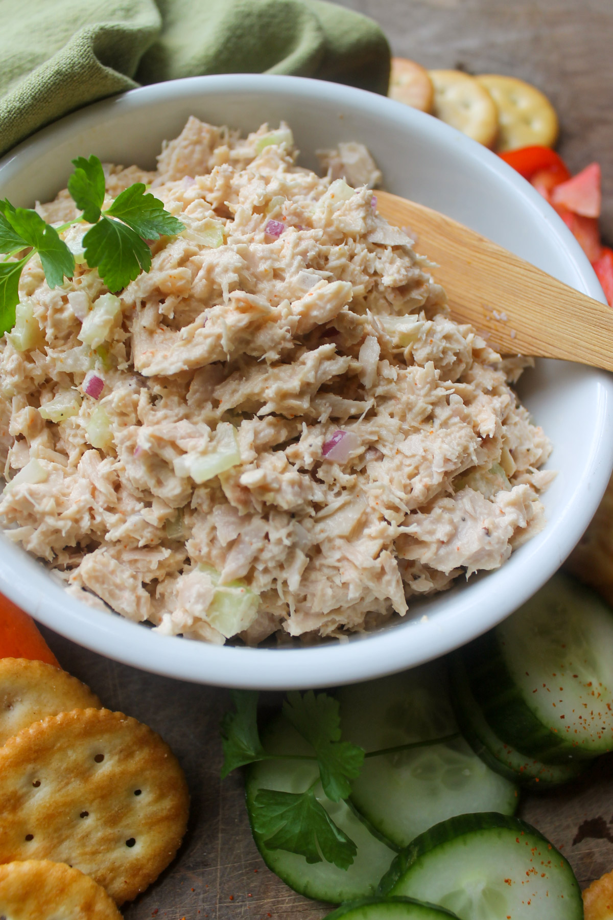 Tuna salad in a bowl served with crackers.