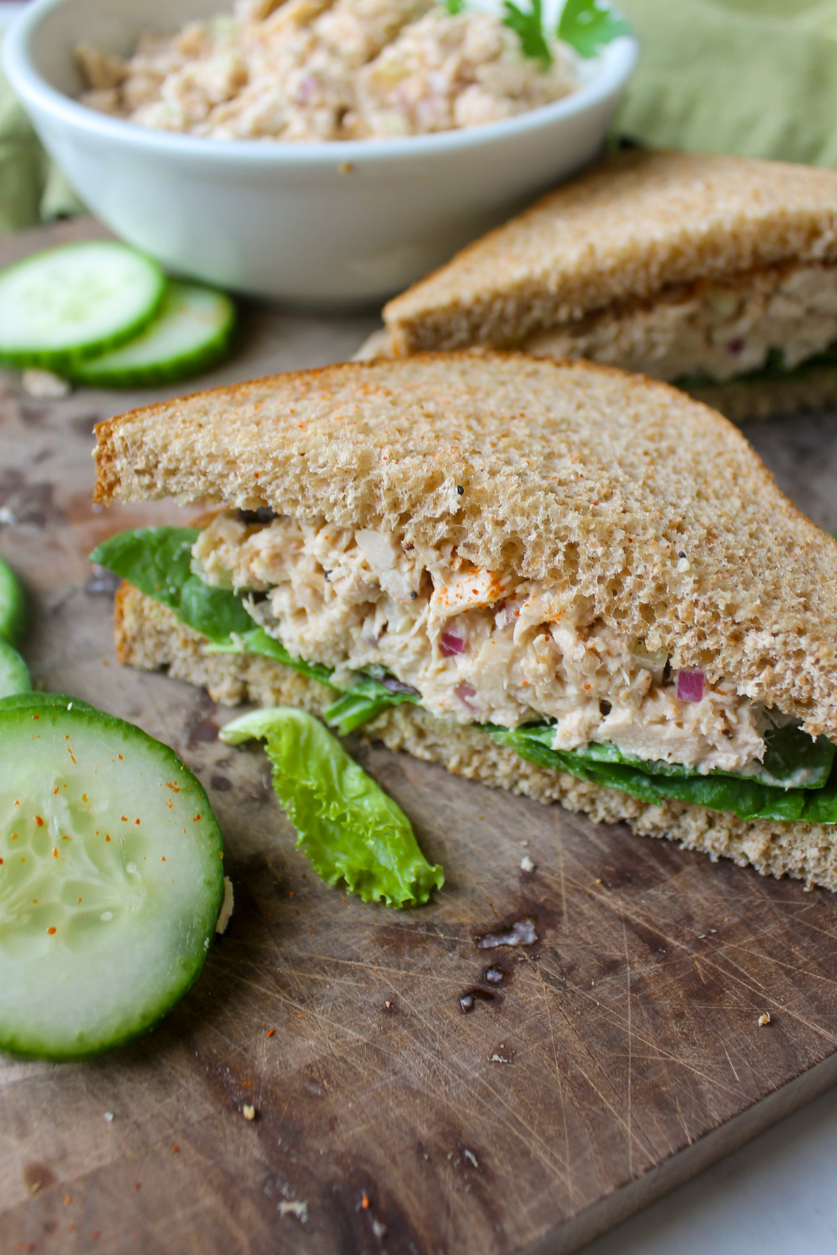 Tuna salad sandwiches on wheat bread with lettuce.