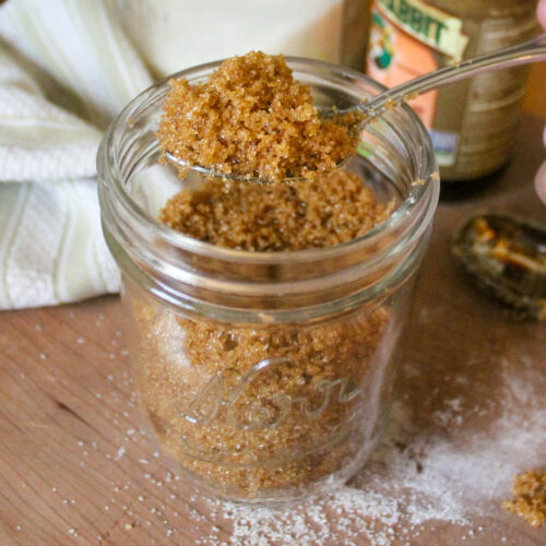 A spoonful of homemade brown sugar from a jar.