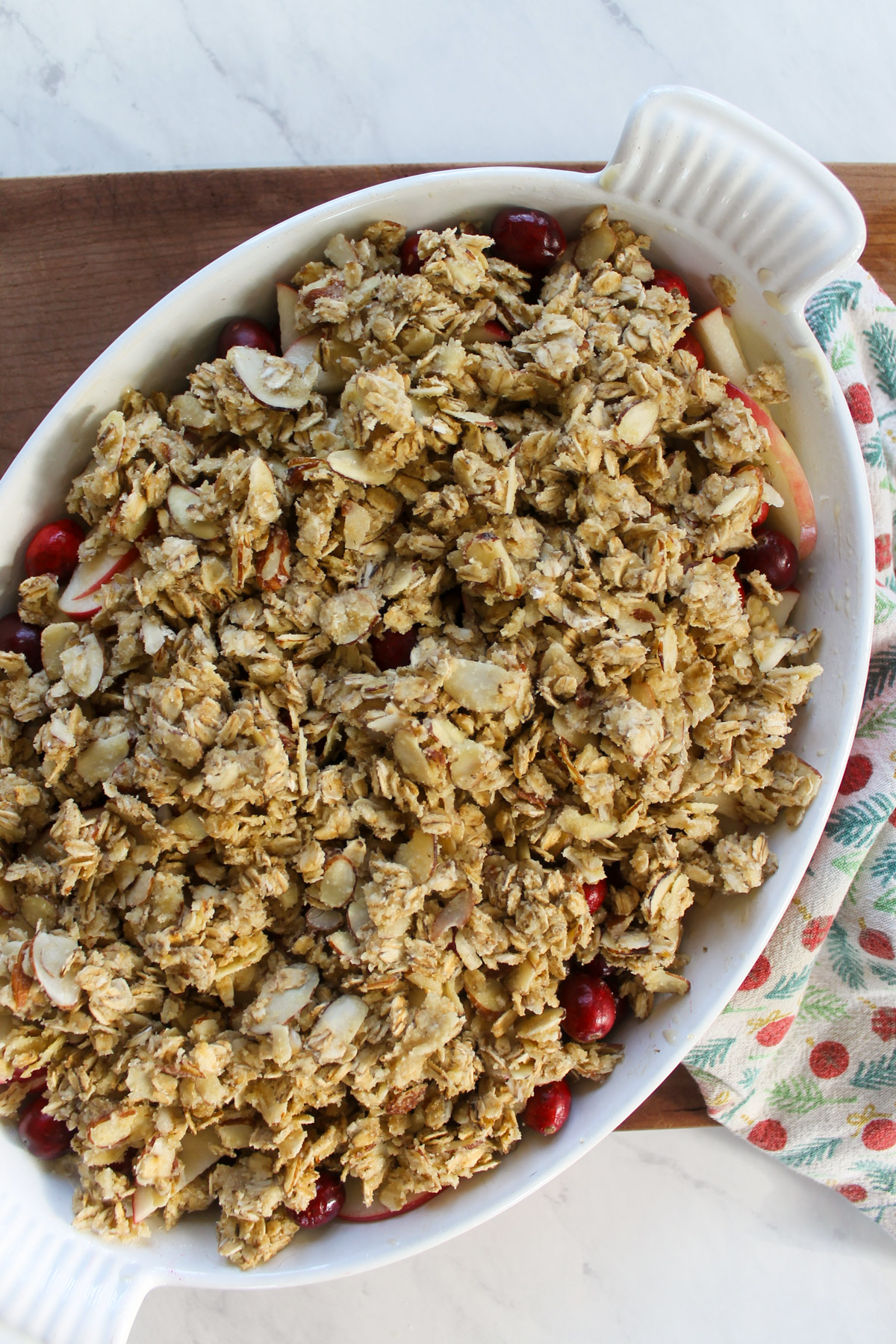 Apple cranberry crisp with butter oat topping ready to be baked.