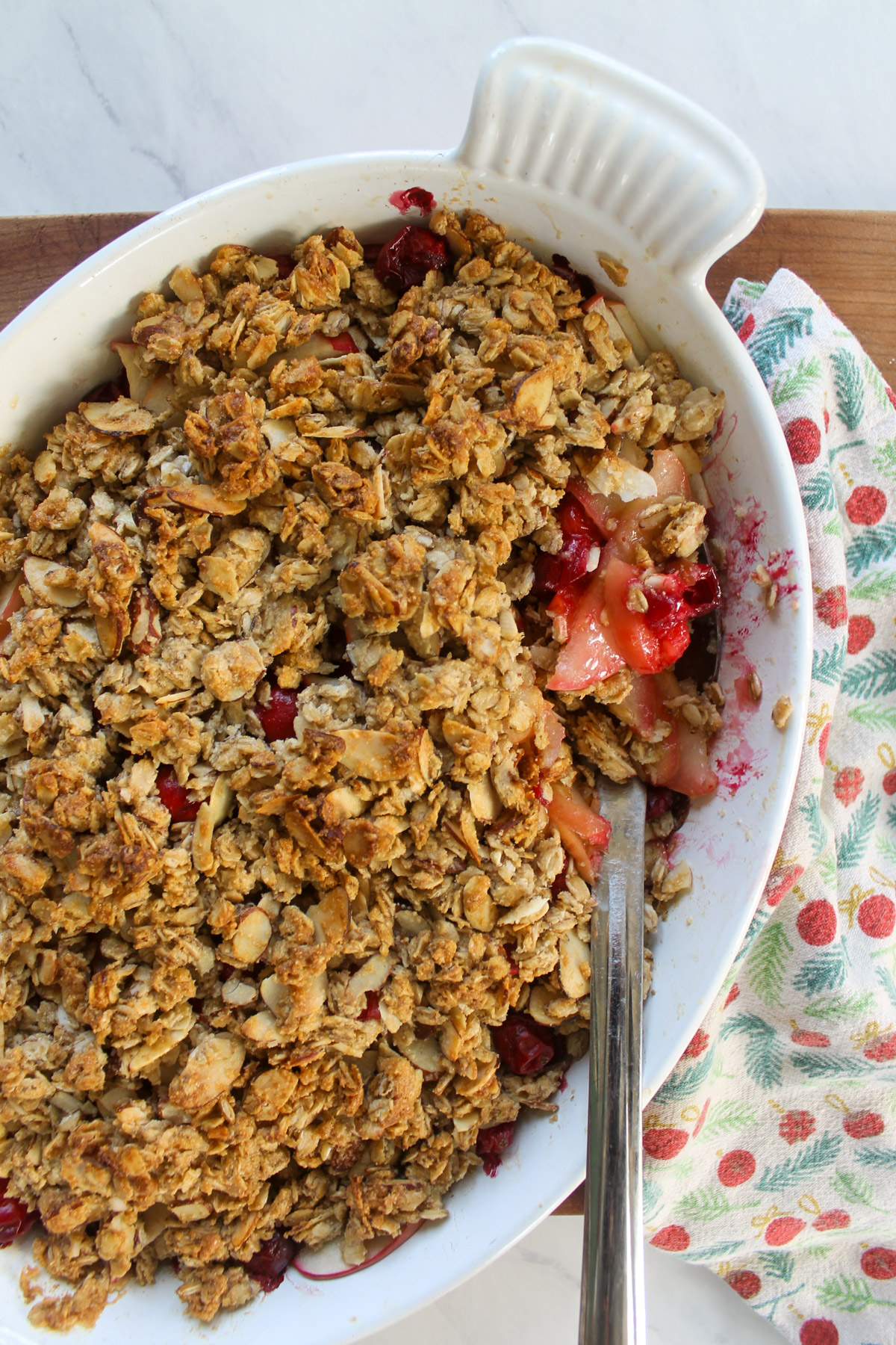 Baked apple cranberry crisp in a white dish.