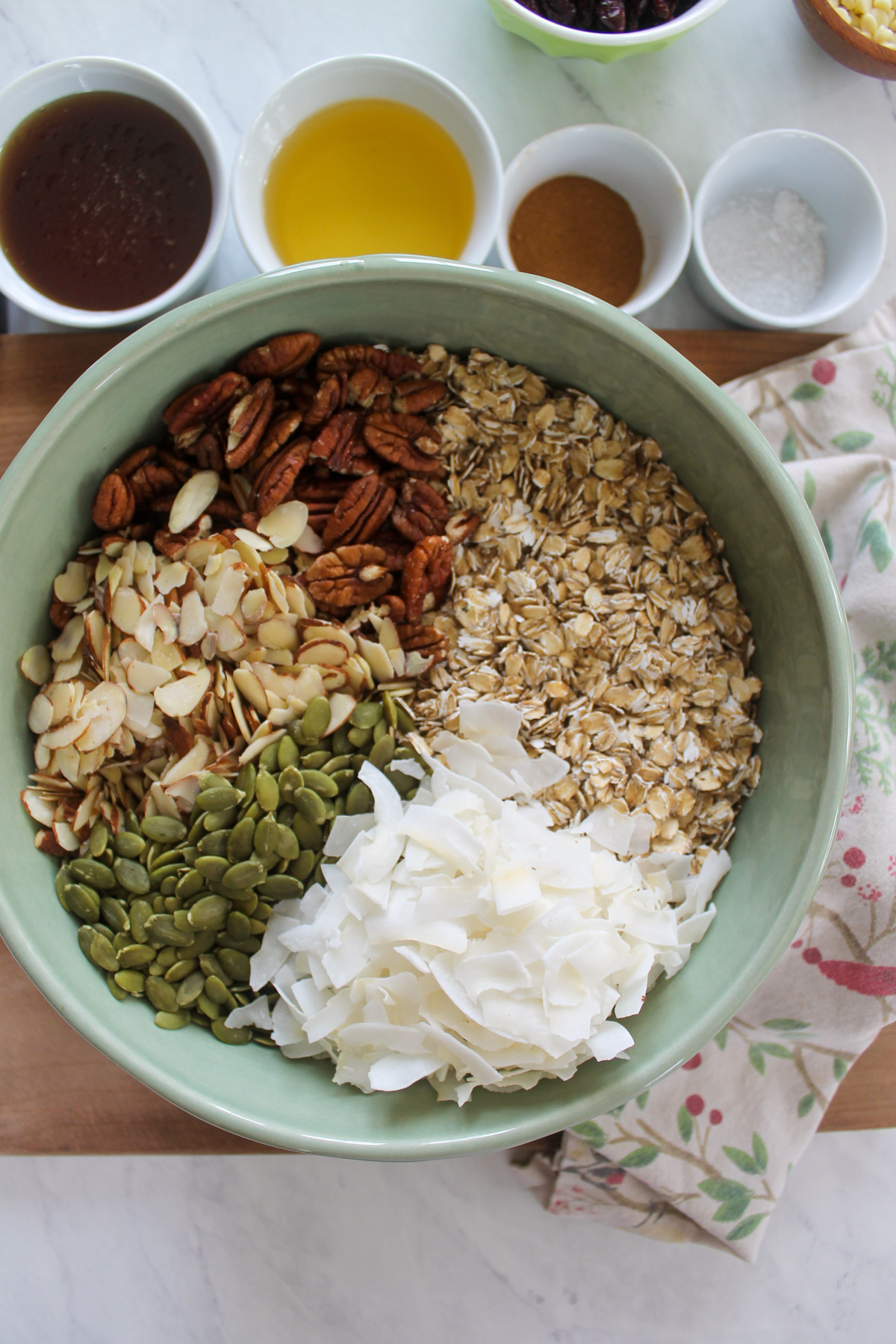 A bowl of oats, nuts, seeds and coconut flakes for granola.