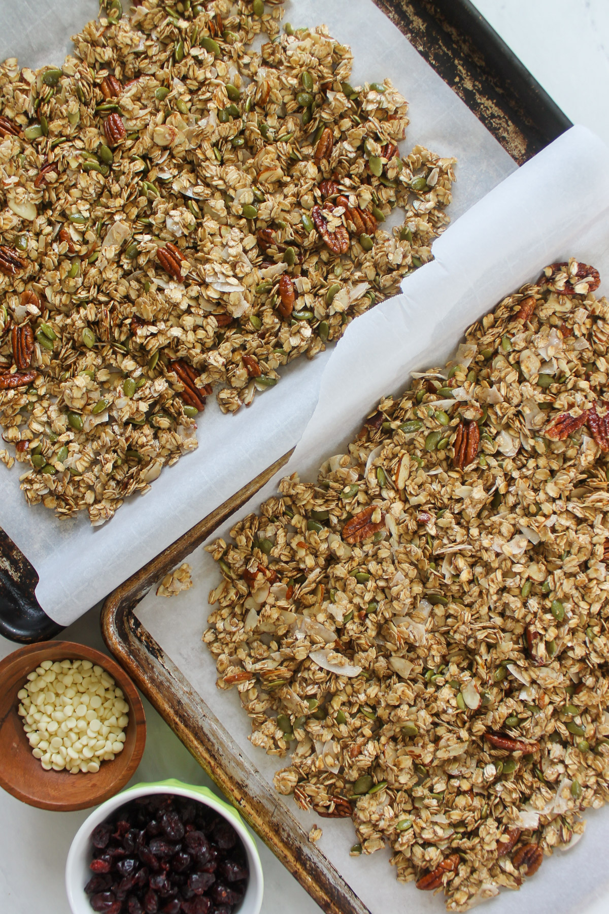 Two pans of granola ready to bake.