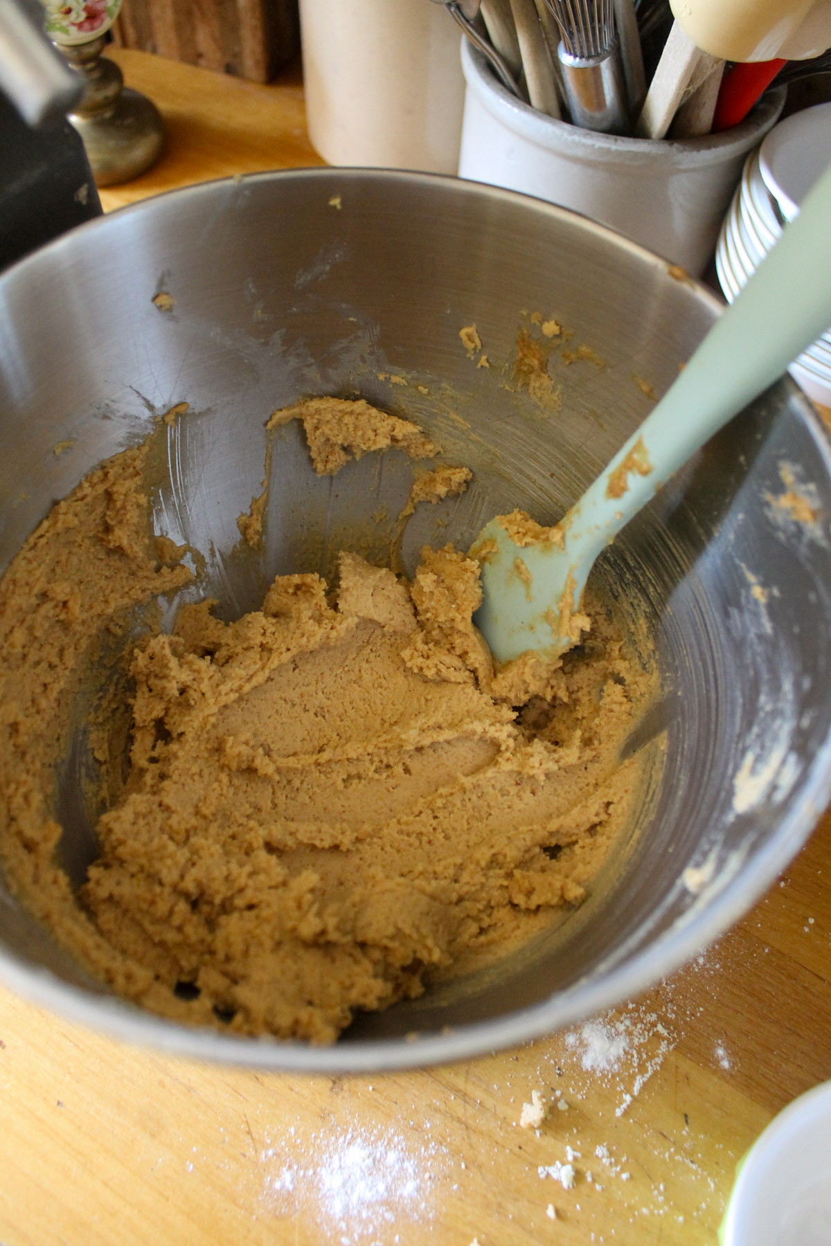 Peanut butter blossom cookie batter in a mixer bowl.